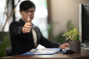 Businessman giving a thumbs up photo