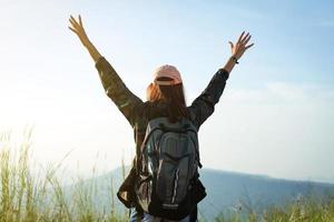 mujer viajera con los brazos alzados foto