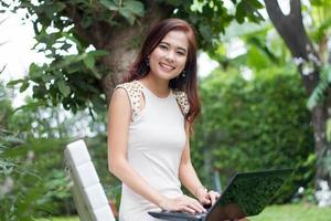 Woman using laptop outside photo