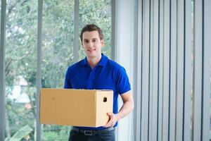 Delivery man holding a package  photo