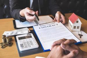 Real estate agent handing pen to client photo