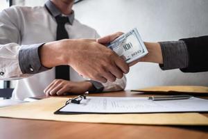 Two businessmen are conducting a business transaction  photo