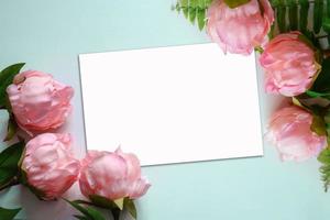 Top view of peonies with white card photo