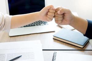 Coworkers fist bump in meeting  photo