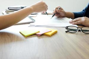 Two professionals meeting and pointing at documents  photo