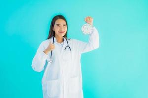 Portrait of female doctor alarm clock photo