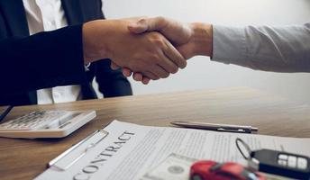 Client shaking hands with car salesman  photo