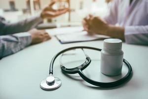 Close up of stethoscope and medicine bottle photo