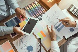 Two business partners working together at desk photo