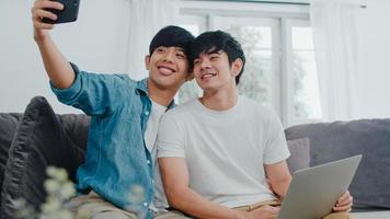 Young gay couple take a selfie at home. photo
