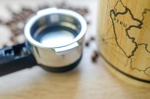 Coffee beans with cup and keg on wooden table photo