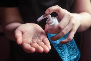 Close-up of person applying hand sanitizer   photo