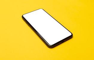 Smart phone on yellow background  photo