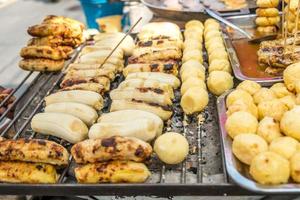 Grilled banana and sweet potato for sale at a local market photo