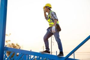 Construction worker wearing safety harness photo