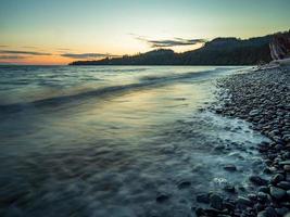 Rocky seashore with mountains photo