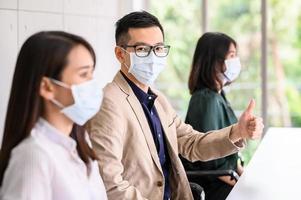Row of people wearing protective face masks for safety photo