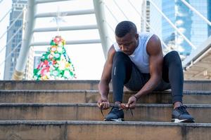 Man tying running shoes photo