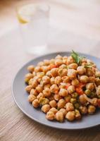Cooked chickpea dish on plate photo