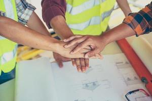 Three men join hands photo