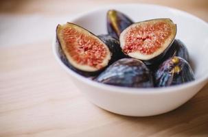 Sliced fruit in ceramic bowl photo