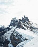 Snow-capped mountains under cloudy blue sky photo