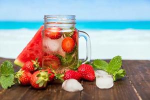 Strawberry drink against tropical background photo