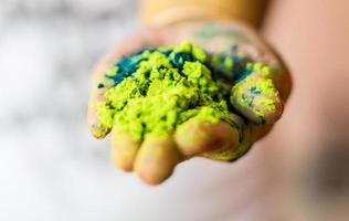 Person holding green powder photo