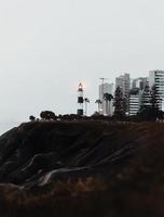 Illuminated lighthouse in the fog photo