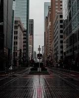 Empty street between buildings in city