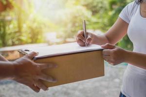 Woman signing for delivery photo