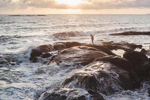 Person standing on brown rock formation photo