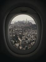 Airplane window looking out towards New York City photo