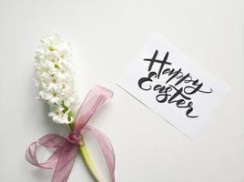 Happy Easter sign with white flowers photo