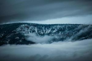 Mountain range surrounded by fog photo