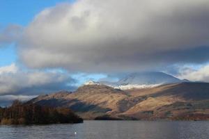 Clouds hovering over mountains photo