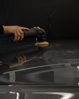 Side shot of a hand polishing car