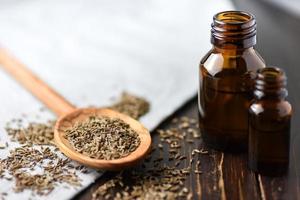 Cumin seeds and oil in bottles