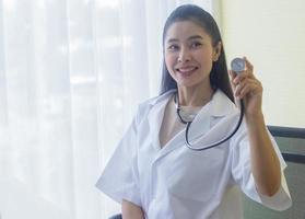 Beautiful young woman doctor stands smiling photo