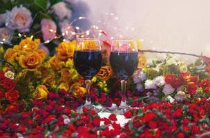 Red wine in clear glass with floral decor photo