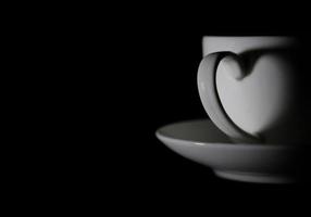 Cup and saucer on black background photo