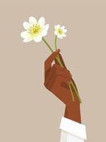 mano femenina negra que sostiene las flores vector