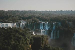 Aerial photo of waterfall surrounded by green trees