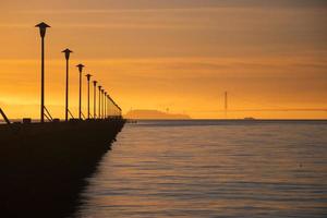 Silhouette of bridge during sunset photo