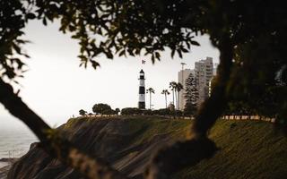 White lighthouse tower beside sea photo