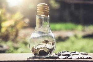 Coins in glass bottle with money  photo