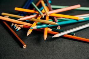 Colorful pencils randomly stacked photo