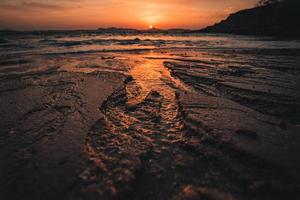 Closeup of sand at beach with sunset photo