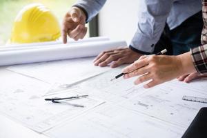 Construction architects discuss a blueprint  photo