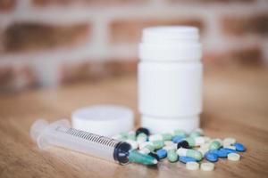 Medicine supplements on wooden background photo